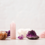 A variety of pink, purple, orange, and white crystals on a white table