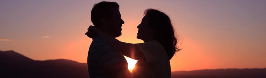 couple-standing-in-the-sunset