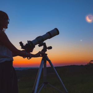 woman pointing a telescope up at a moon in a blue sky